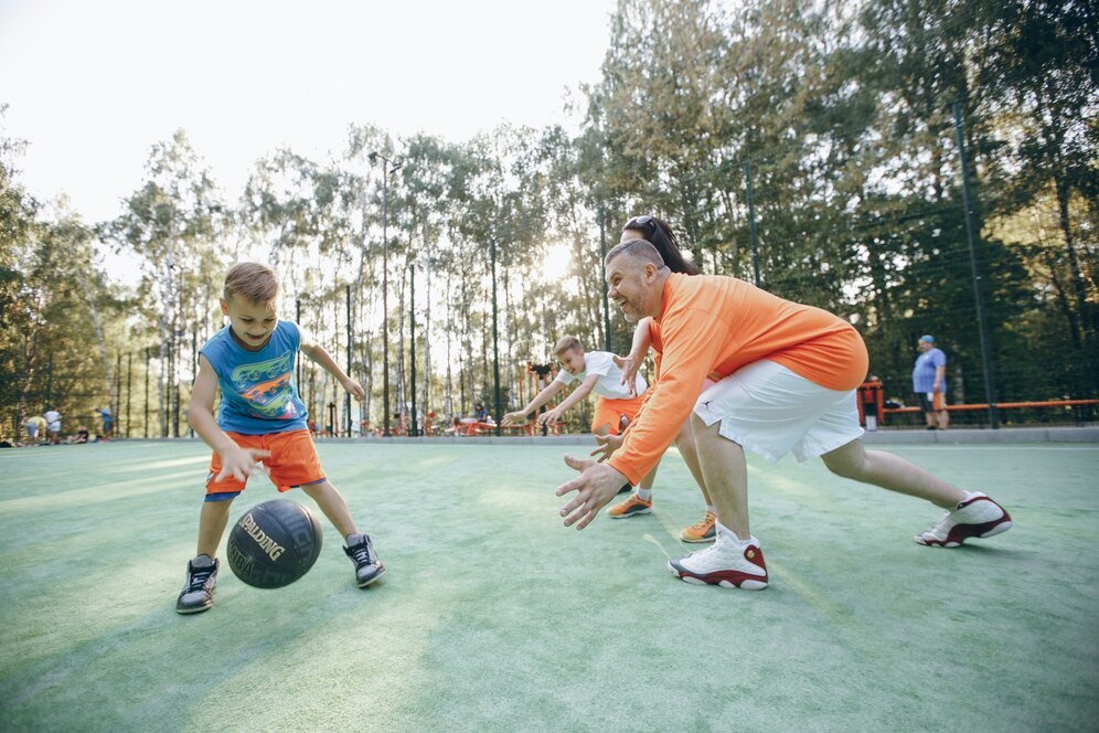 parents playing basketball with their son